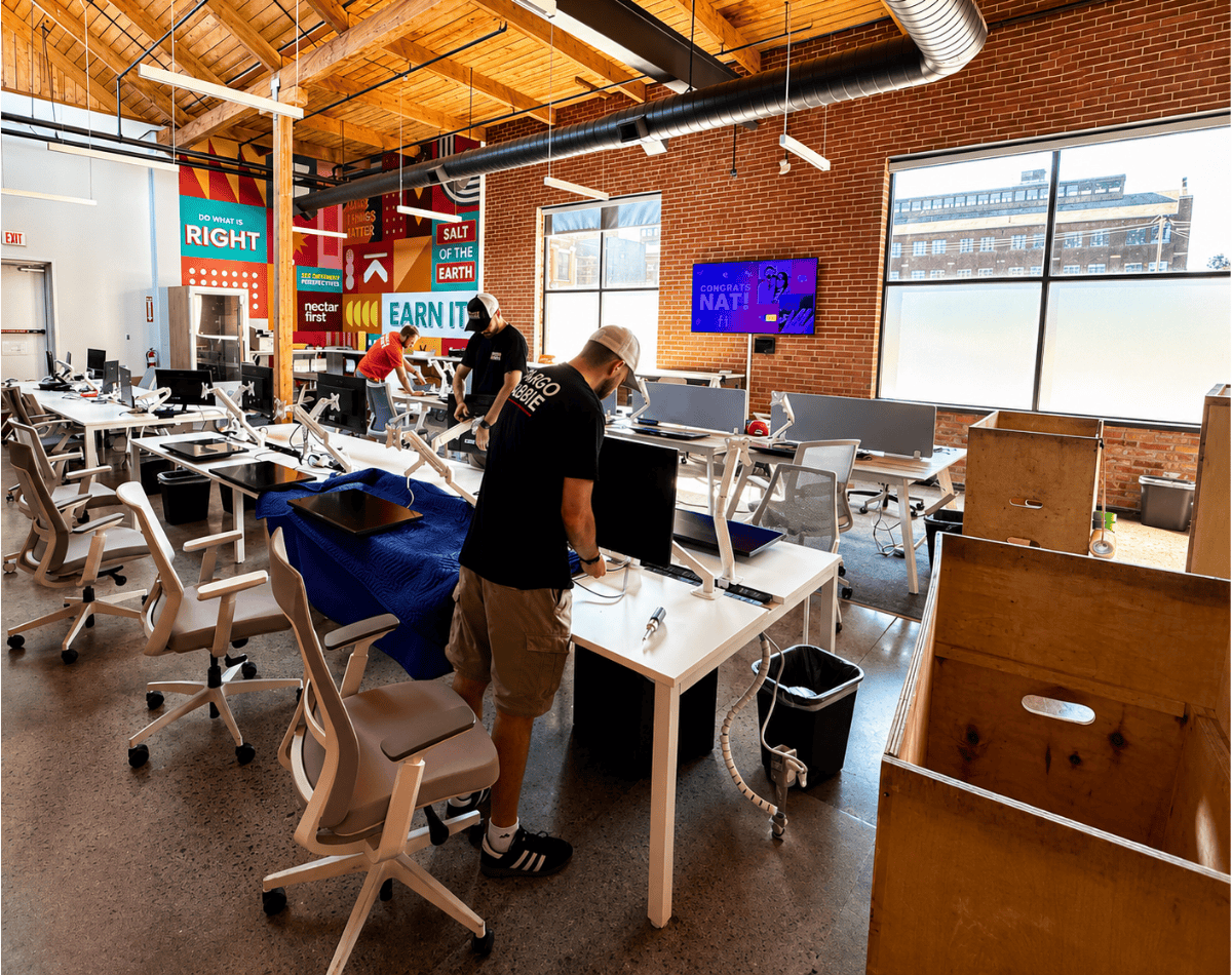 CARGO CABBIE office movers setting up desks and monitors in a Toronto business space